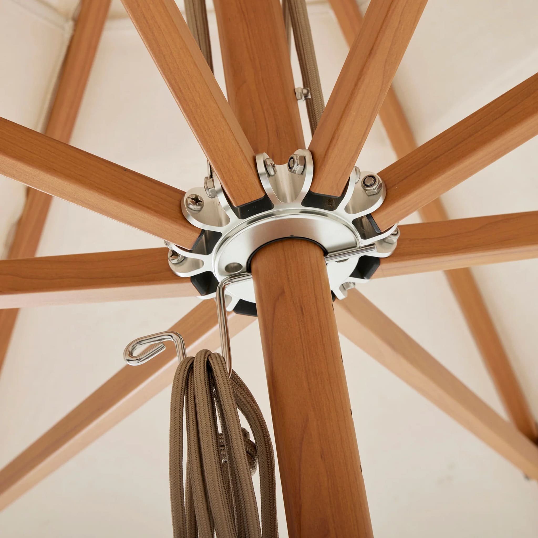 Timber-look umbrella with scratch-resistant Interpon finish and marine-grade stainless steel fixtures for durability and style.