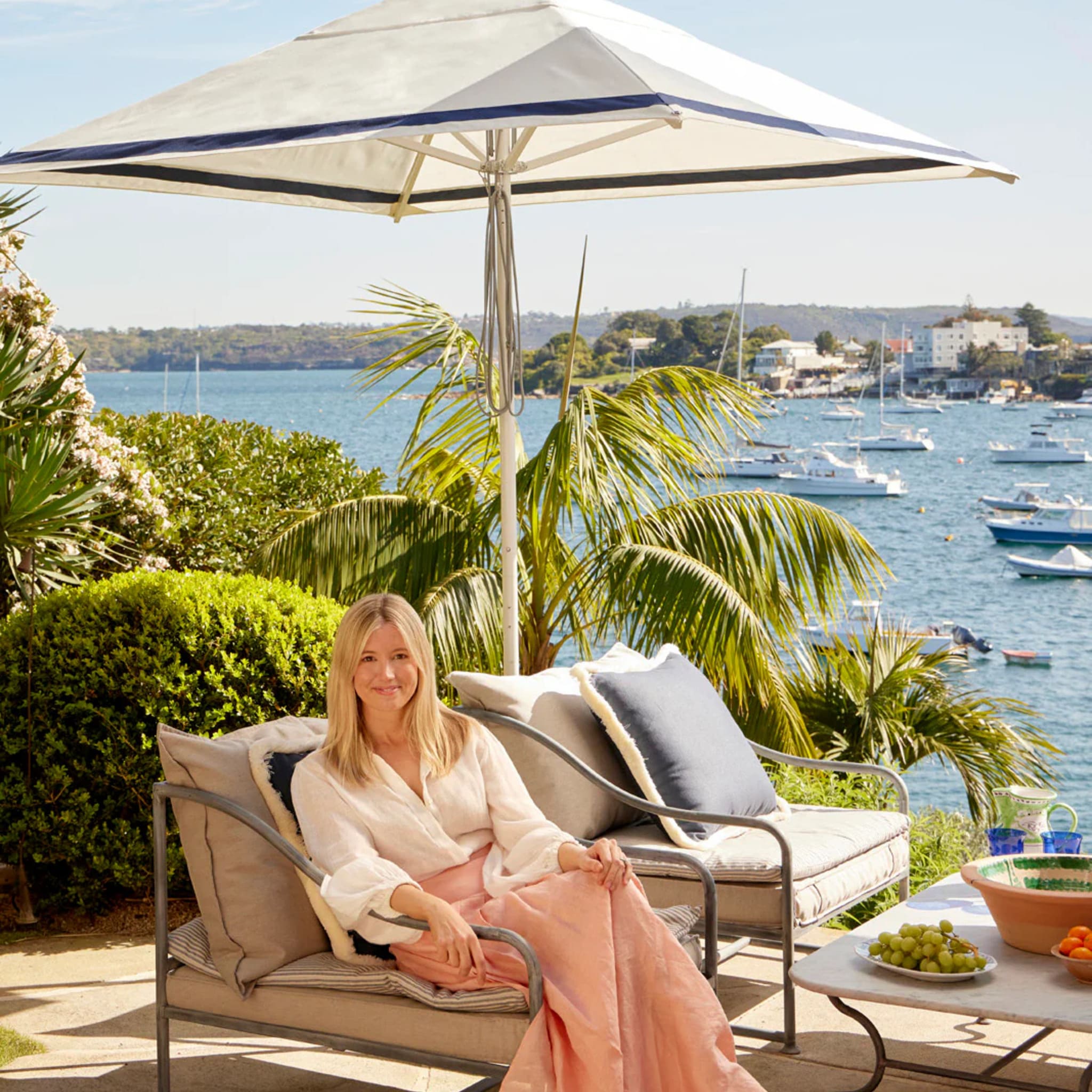 Sophisticated Regatta Patio Umbrella by Lucy Montgomery, inspired by yacht upholstery and classic 90s fashion.